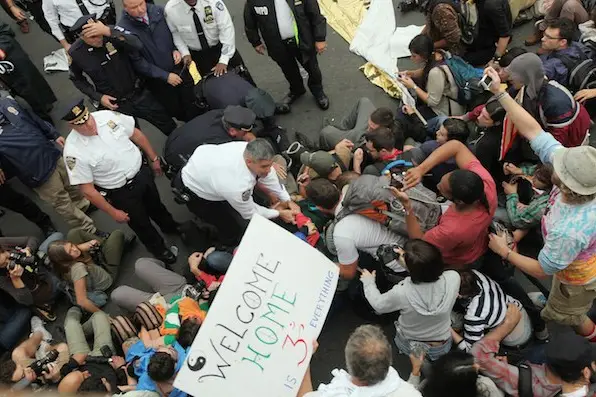 Police arrest demonstrators affiliated with the Occupy Wall Street movement after they attempted to cross the Brooklyn Bridge on the motorway on October 1, 2011